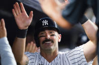 New York Yankees' Anthony Rizzo is congratulated in the dugout after hitting a two-run home run during the fifth inning of the team's baseball game against the Detroit Tigers on Friday, June 3, 2022, in New York. (AP Photo/Frank Franklin II)