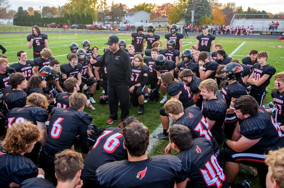 Metamora head football coach Jared Grebner talks with his team after their Class 5A first-round playoff victory over Jacksonville on Saturday, Oct. 29, 2022 in Metamora.