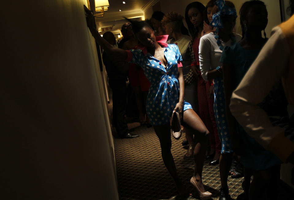 Fashion models wait backstage at the first day of the Soweto Fashion Week in Soweto, South Africa , Thursday May 24, 2012. Designers and entrepreneurs who have got together to put on a fashion show in Soweto are inspired by the famed township's creativity and history.(AP Photo/Jerome Delay)