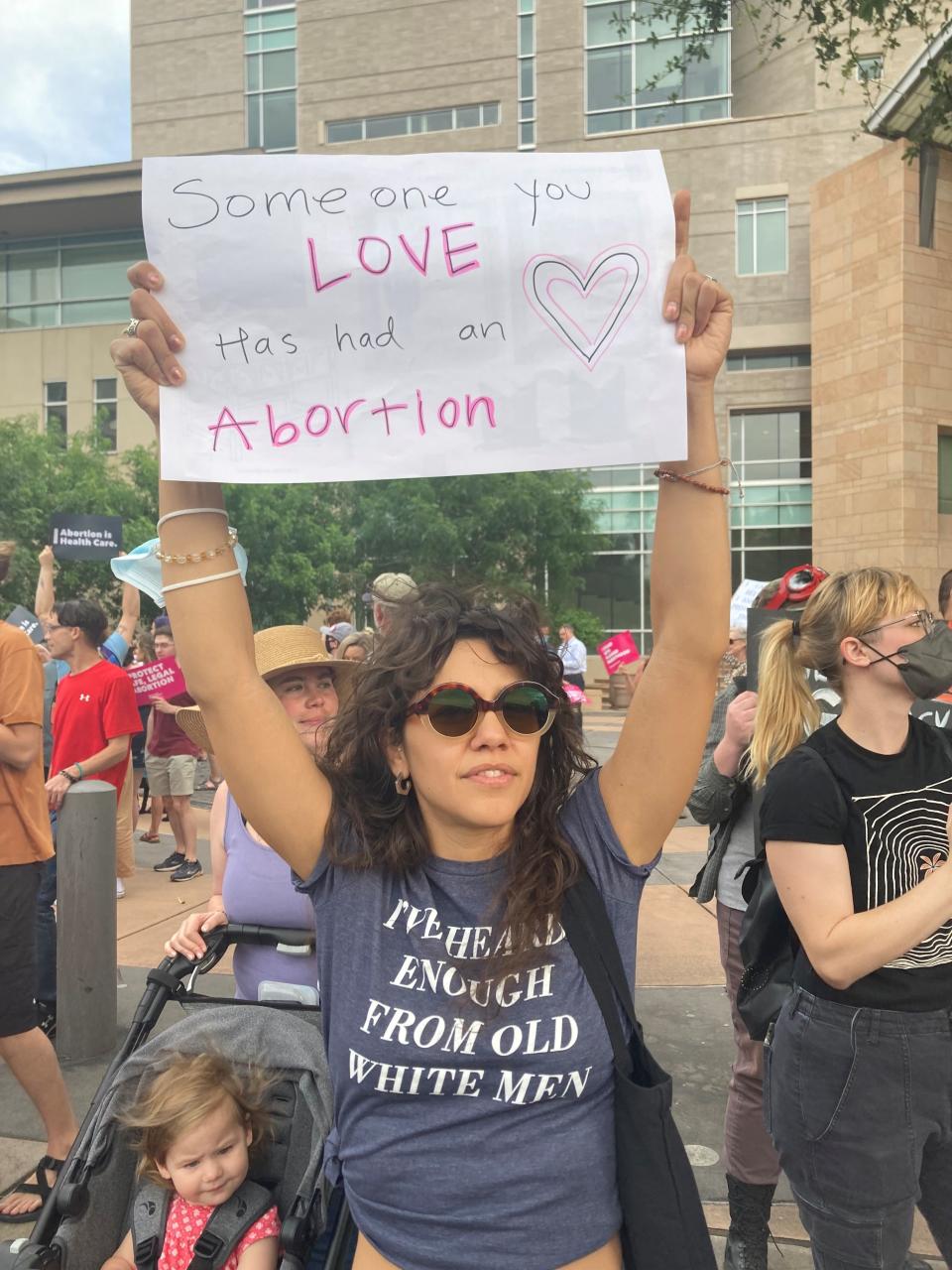 Camille Gonzalez holds up at sign at a rally in Tucson supporting abortion rights