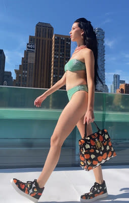 Flying Solo model showcasing the Cleopatra tote and the Nefertiti sneakers. Photo Credit: Kyra Surgent