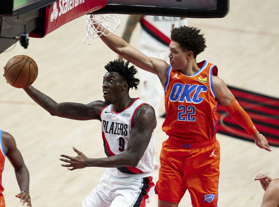 Portland Trail Blazers forward Nassir Little, left, shoots in front of Oklahoma City Thunder forward Isaiah Roby during the first half of an NBA basketball game in Portland, Ore., Monday, Jan. 25, 2021. (AP Photo/Craig Mitchelldyer)