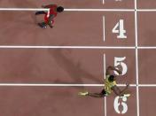 Usain Bolt of Jamaica crosses the finish line ahead of Justin Gatlin of the U.S. as they compete in the men's 200 metres final during the 15th IAAF World Championships at the National Stadium in Beijing, China, August 27, 2015. REUTERS/Pawel Kopczynski