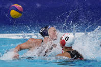 Canada's Gurpreet Sohi (6) shoots over the reach of United States' Kaleigh Gilchrist, left, during a quarterfinal round women's water polo match at the 2020 Summer Olympics, Tuesday, Aug. 3, 2021, in Tokyo, Japan. (AP Photo/Mark Humphrey)