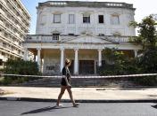 A woman walks in the abandoned coastal area of Varosha