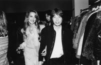 <p>Rolling Stones frontman, Mick Jagger, makes his way through a crowd backstage while his girlfriend, model Jerry Hall, follows. The couple began dating in the late '70s (while Jagger was still married to his first wife, Bianca Jagger) and were together until 1999. </p>