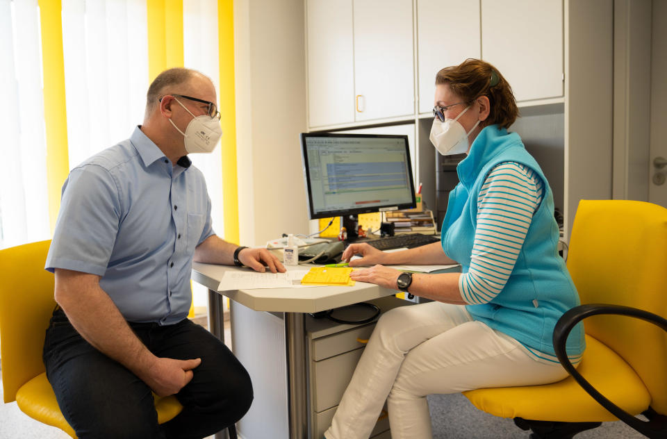 Doctor Birgitt Lucas informs a 49-year-old patient about the COVID-19 vaccine before vaccinating him, March 25, 2021, in the district of Hof, in Germany's Bavaria state. / Credit: Nicolas Armer/picture alliance/Getty