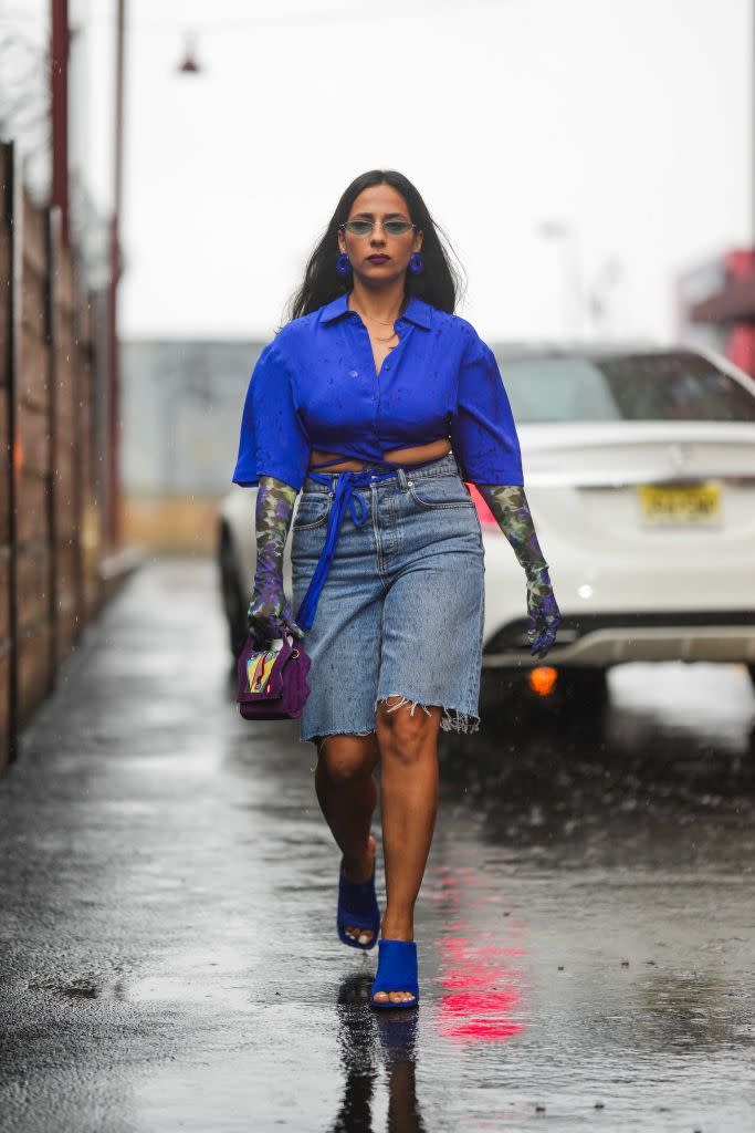 new york, new york september 10 samia laaboudi wears sunglasses, a blue shirt, a purple floral print long gloves, a belt, blue denim ripped shorts, a bag, blue shoes, outside ulla johnson, during new york fashion week, on september 10, 2023 in new york city photo by edward berthelotgetty images
