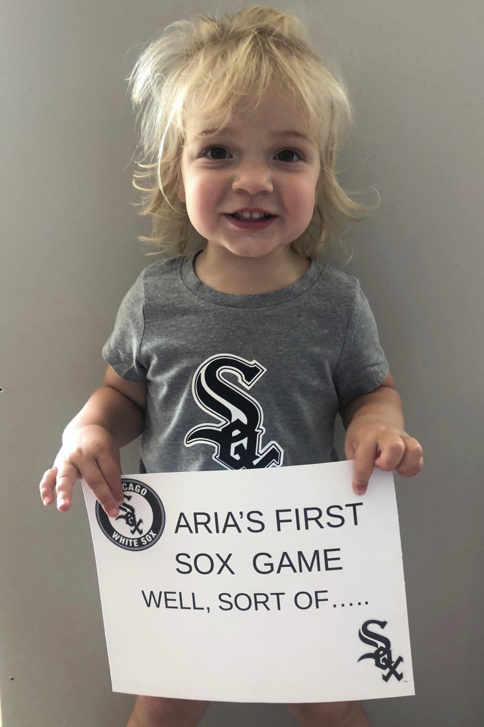 This photo provided by Michael Izzo shows two-year-old Aria Izzo's photo that will appear in a fan cutout when the Chicago White Sox open the season July 24 against the Minnesota Twins. Michael and Megan Izzo of Oswego, Illinois, wanted to take their 2-year-old daughter, Aria, to her first White Sox game this year. When the pandemic spoiled that plan, the Izzos made sure to get their daughter’s face on a cutout that can eventually become a family keepsake. (Michael Izzo via AP)