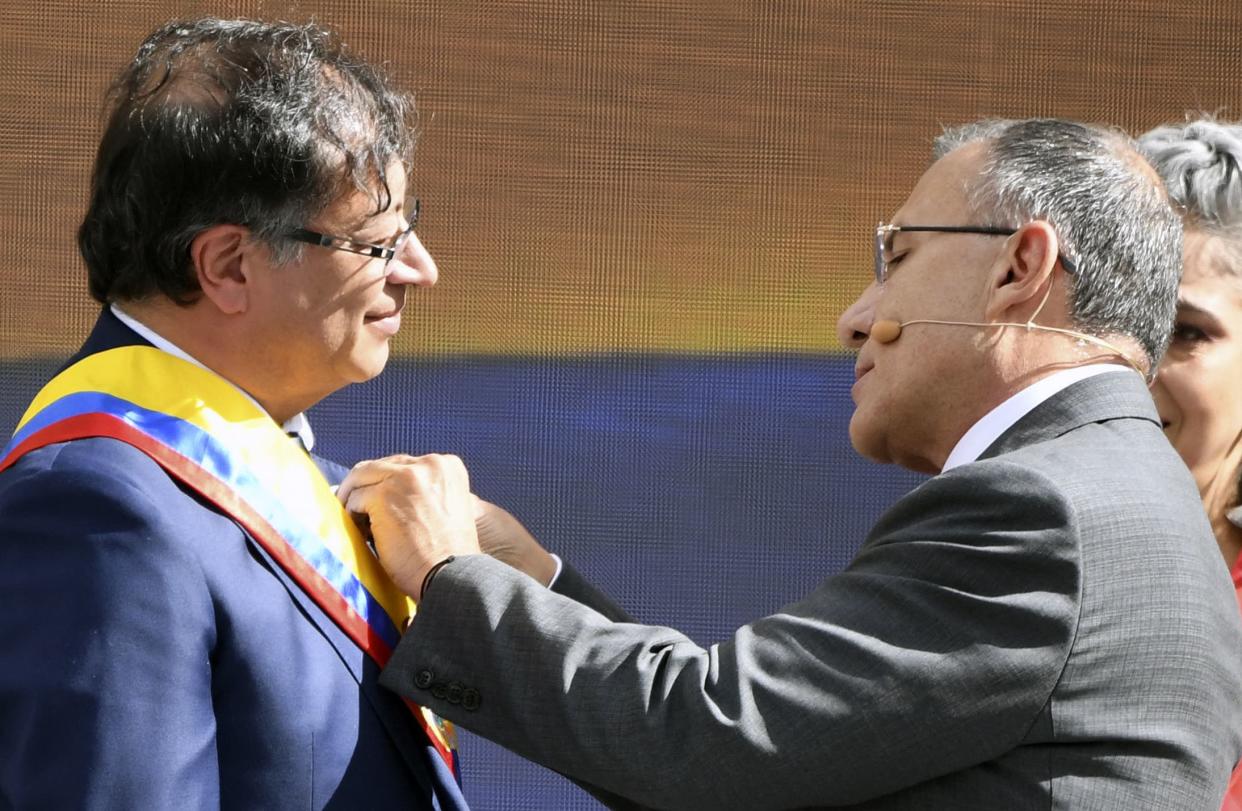 The president of the Congress Roy Barreras (R) adjusts the presidential sash to Colombia's new President Gustavo Petro (L) during the inauguration ceremony at the Bolivar square in Bogota, on August 7, 2022.