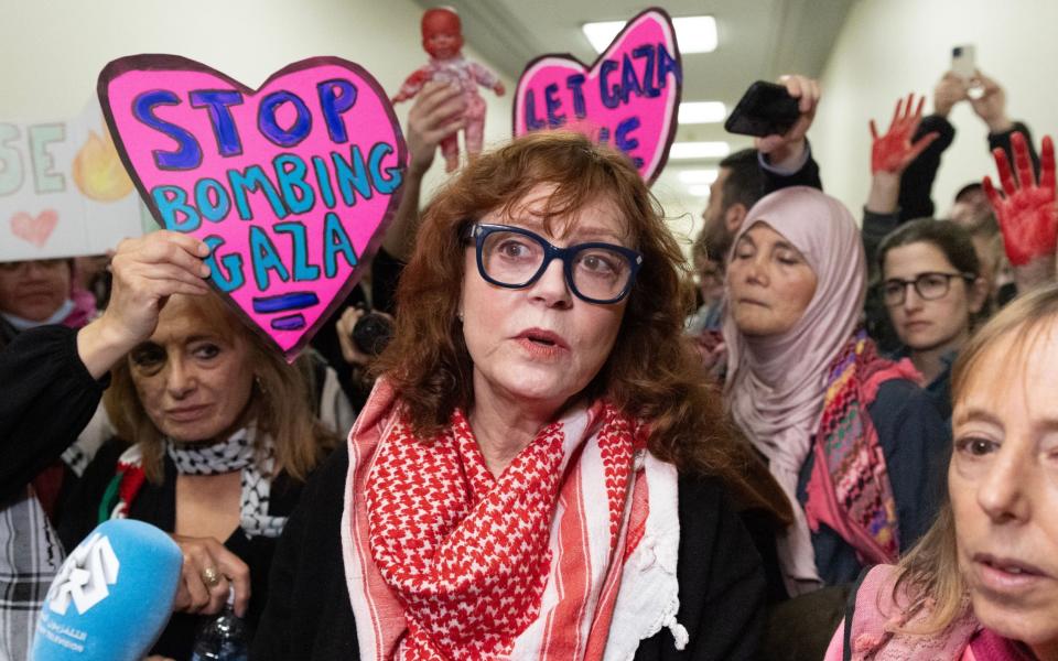 US actress and activist Susan Sarandon (C) speaks to members of the news media beside a group of people advocating in support of Palestine