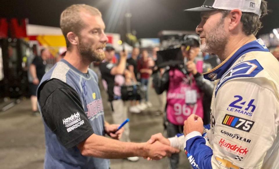 A firefighter from Le Mans meets Jimmie Johnson at the Circuit de la Sarthe.