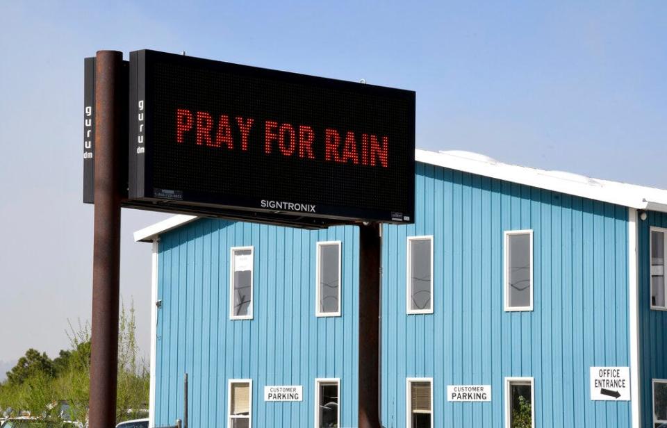 An electronic sign outside a business in Las Vegas, New Mexico, on Wednesday, May 4, 2022, asks passersby to "Pray for Rain" as a massive wildfire spreads in the nearby mountains. Many New Mexico families are deep-rooted not only in the land but in their faith.