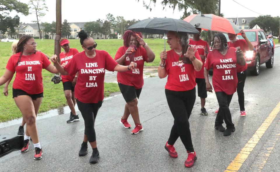 Members of Line Dancing by Lisa perform during the Juneteenth parade Saturday in Daytona Beach.
