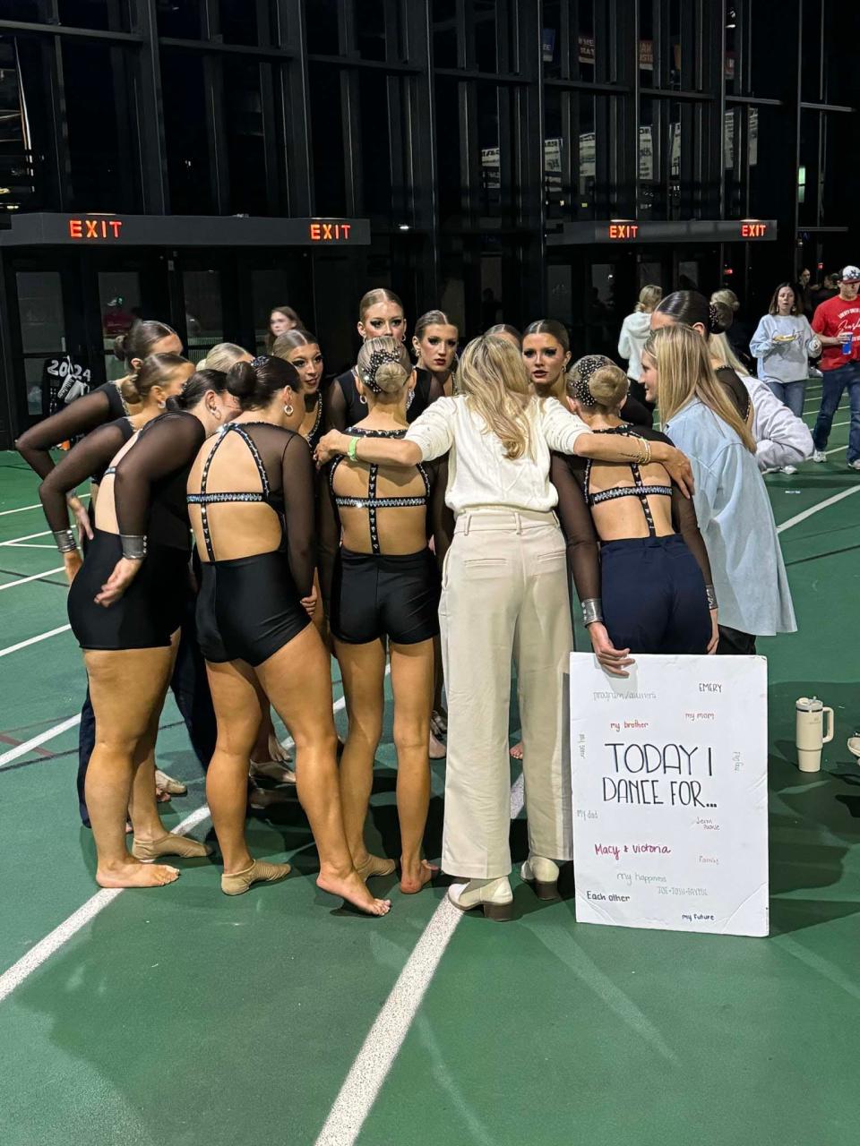 Coach Macy Brink (center) gives a pep talk to the Farragut High School dance team in Nashville, Nov. 2023.