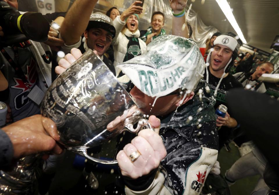 Saskatchewan Premier Brad Wall drinks from the Grey Cup after the Saskatchewan Roughriders defeated the Hamilton Tiger-Cats in the CFL's 101st Grey Cup championship football game in Regina, Saskatchewan November 24, 2013. REUTERS/Mark Blinch (CANADA - Tags: SPORT FOOTBALL)