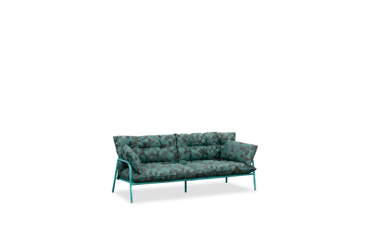 a green metal frame sofa with green pattern cushions