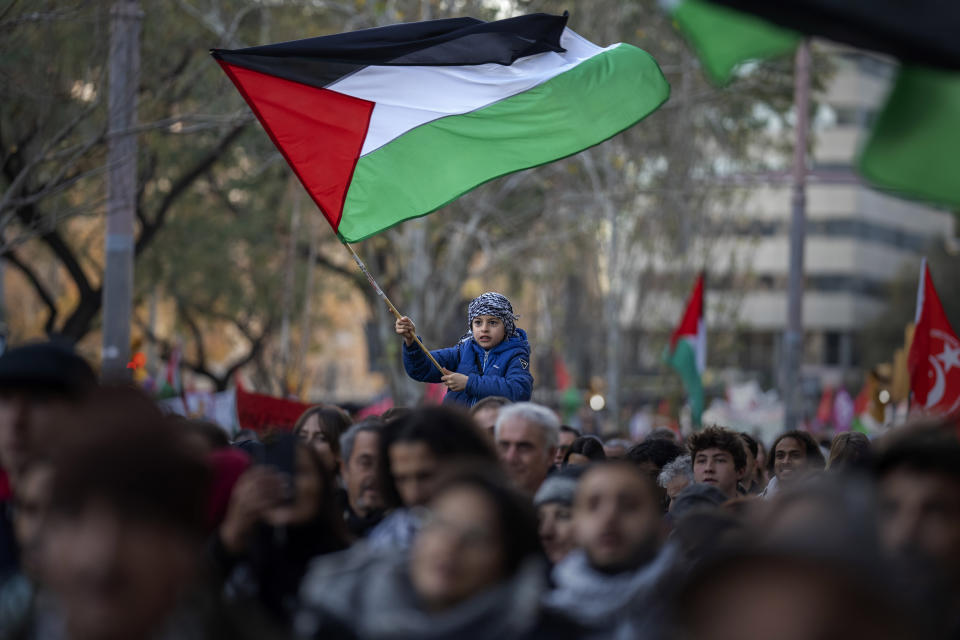 FILE - A boy waves a Palestinian flag as demonstrators march during a protest in support of Palestinians and calling for an immediate ceasefire in Gaza, in Barcelona, Spain, on Jan. 20, 2024. European Union countries Spain and Ireland as well as Norway on Wednesday announced dates for recognizing Palestine as a state. (AP Photo/Emilio Morenatti, File)