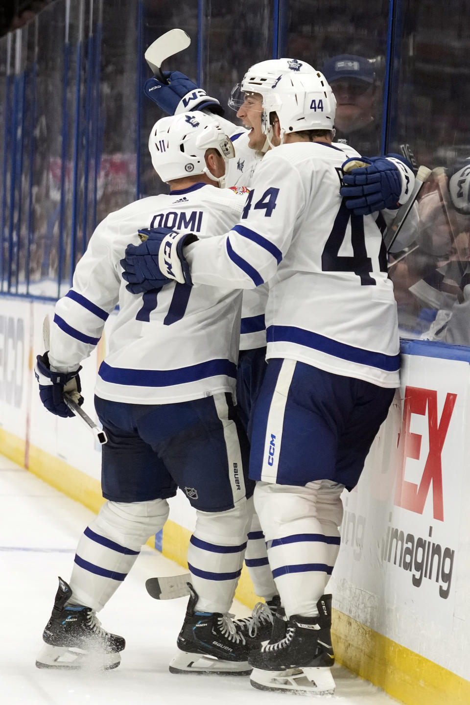 Toronto Maple Leafs left wing Matthew Knies (23, center) celebrates with center Max Domi (11) and defenseman Morgan Rielly (44) after scoring against the Tampa Bay Lightning during the third period of an NHL hockey game Saturday, Oct. 21, 2023, in Tampa, Fla. (AP Photo/Chris O'Meara)