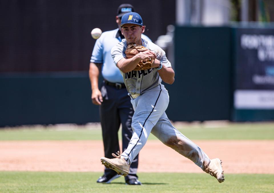 Marcos Torres of Naples High School throws to first base for an out during a state semifinal baseball game between Tampa Jesuit and Naples at Hammond Stadium in Fort Myers on Thursday,May 19, 2022. Naples lost 5-2.