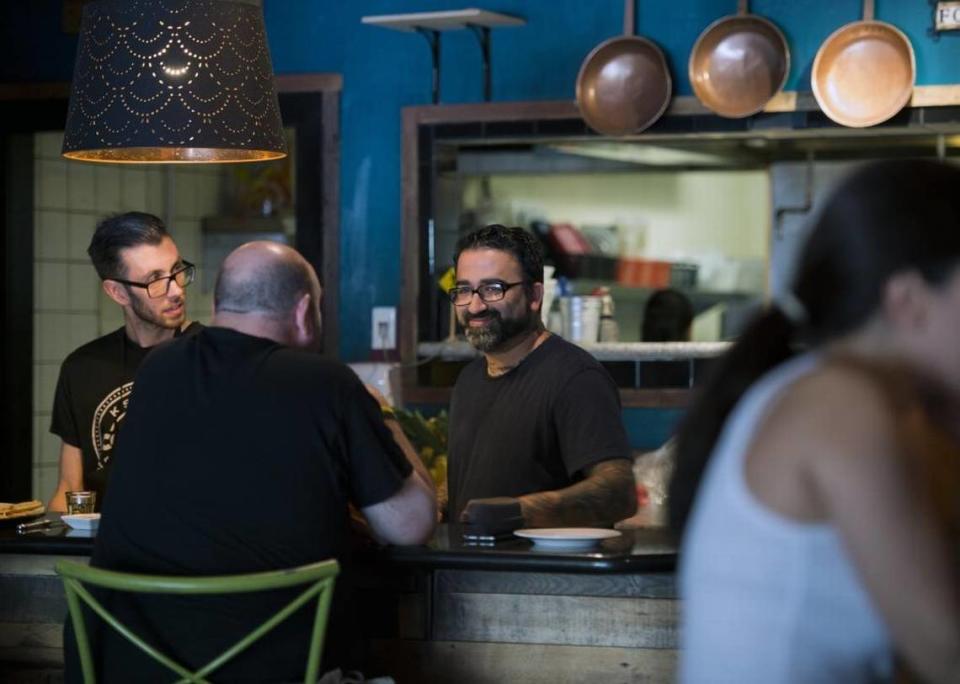 Chef Aimal Formoli, center, talks with a customer in 2016 at Formoli’s Bistro in East Sacramento. The restaurant closed in 2018.