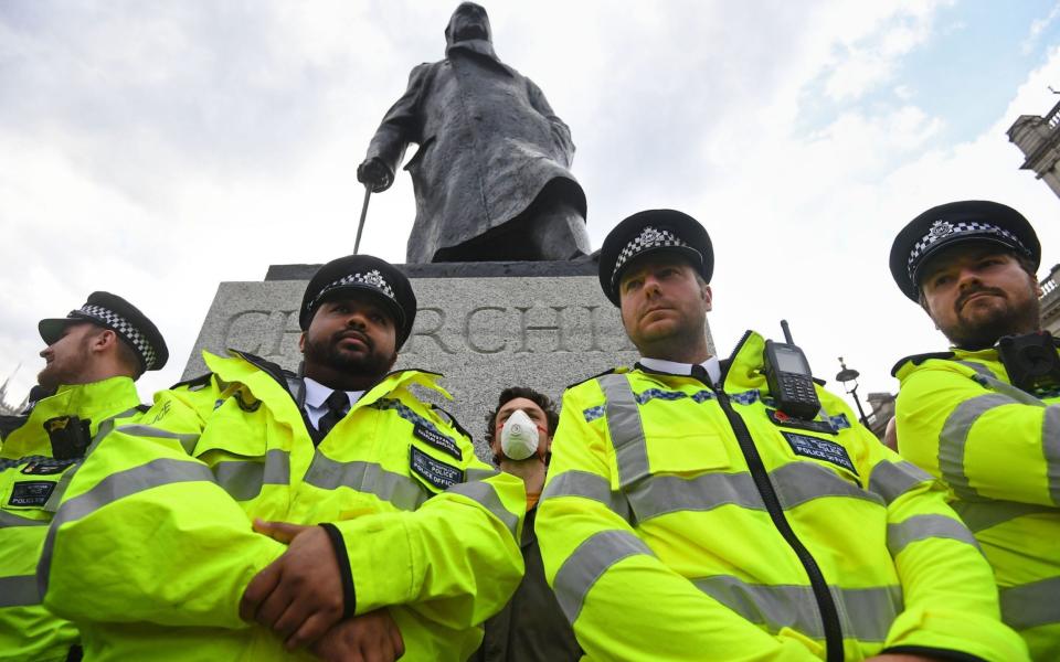 Police surround the Churchill statue in Parliament Square, London during a BLM demonstraton - PA 