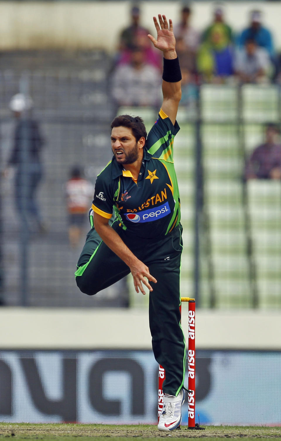 Pakistan’s Shahid Afridi bowls during the Asia Cup one-day international cricket tournament between them in Dhaka, Bangladesh, Sunday, March 2, 2014. (AP Photo/A.M. Ahad)