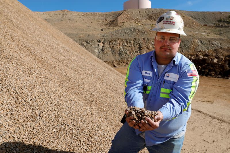 FILE PHOTO: Matt Green, mining/crushing supervisor at MP Materials, displays crushed ore before it is sent to the mill at the MP Materials rare earth mine in Mountain Pass