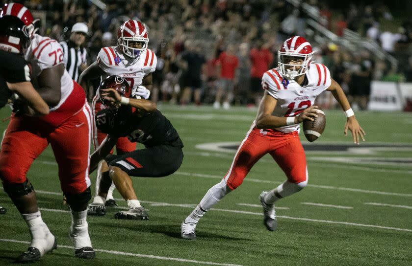 CORONA, CA - SEPTEMBER 02: Mater Dei quarterback Elijah Brown (12) runs the ball in Friday night's football game between Mater Dei vs. Corona Centennial on Friday, Sept. 2, 2022 in Corona, CA. (Jason Armond / Los Angeles Times)