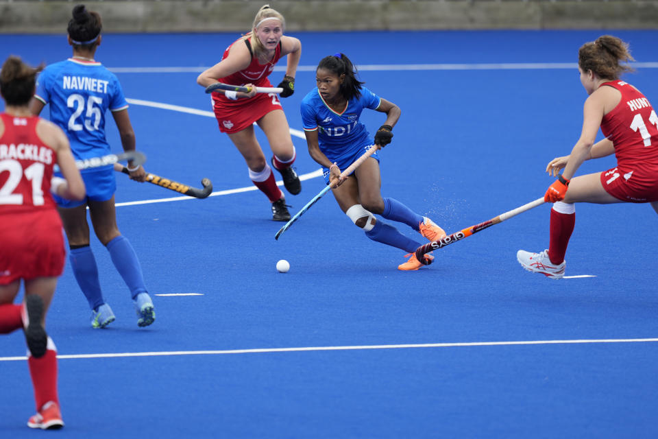 India's Lalremsiami, second right, takes control of the ball during the Women's Pool A hockey match between England and India at the Commonwealth Games in Birmingham, England, Tuesday, Aug. 2, 2022. (AP Photo/Aijaz Rahi)