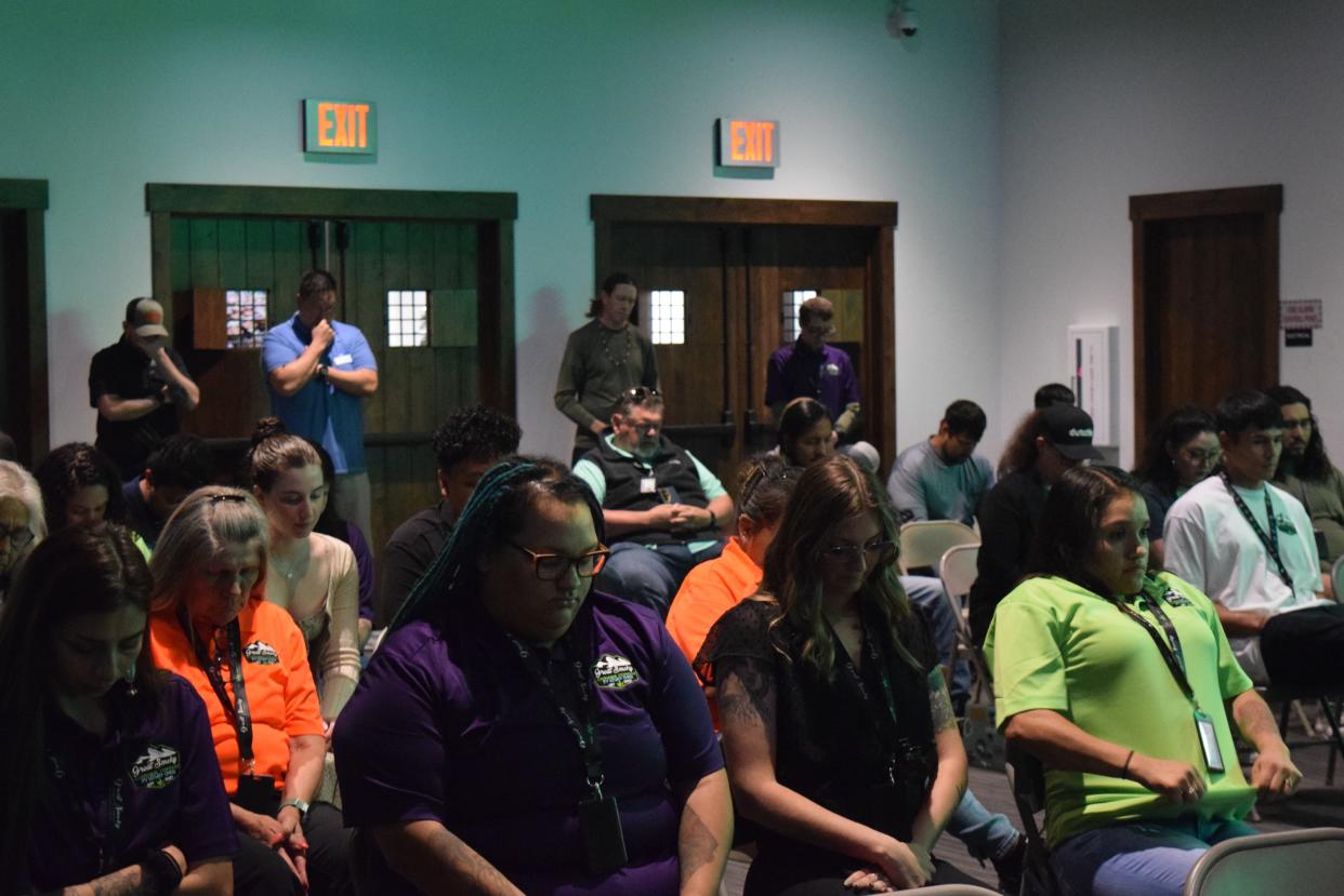 Attendees nod their head as Myrtle Driver says a prayer during the grand opening ceremony of the Eastern Band of Cherokee Indians' Great Smoky Cannabis Co. dispensary in Cherokee, North Carolina. April 20, 2024.