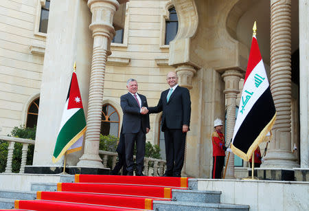 Jordan's King Abdullah shakes hands with Iraq's President Barham Saleh, during his visit in Baghdad, Iraq January 14, 2019. REUTERS/Khalid Al-Mousily