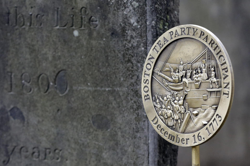 A commemorative marker stands, Tuesday, Nov. 27, 2018, at Central Burying Ground on Boston Common at the gravesite of Bartholomew Trow, a participant in the Dec. 16, 1773 protest known as the Boston Tea Party. This year is the 245th anniversary of the protest during which colonists protesting taxation without representation threw British tea into Boston Harbor, considered a pivotal event that led to the American Revolution. (AP Photo/Elise Amendola)