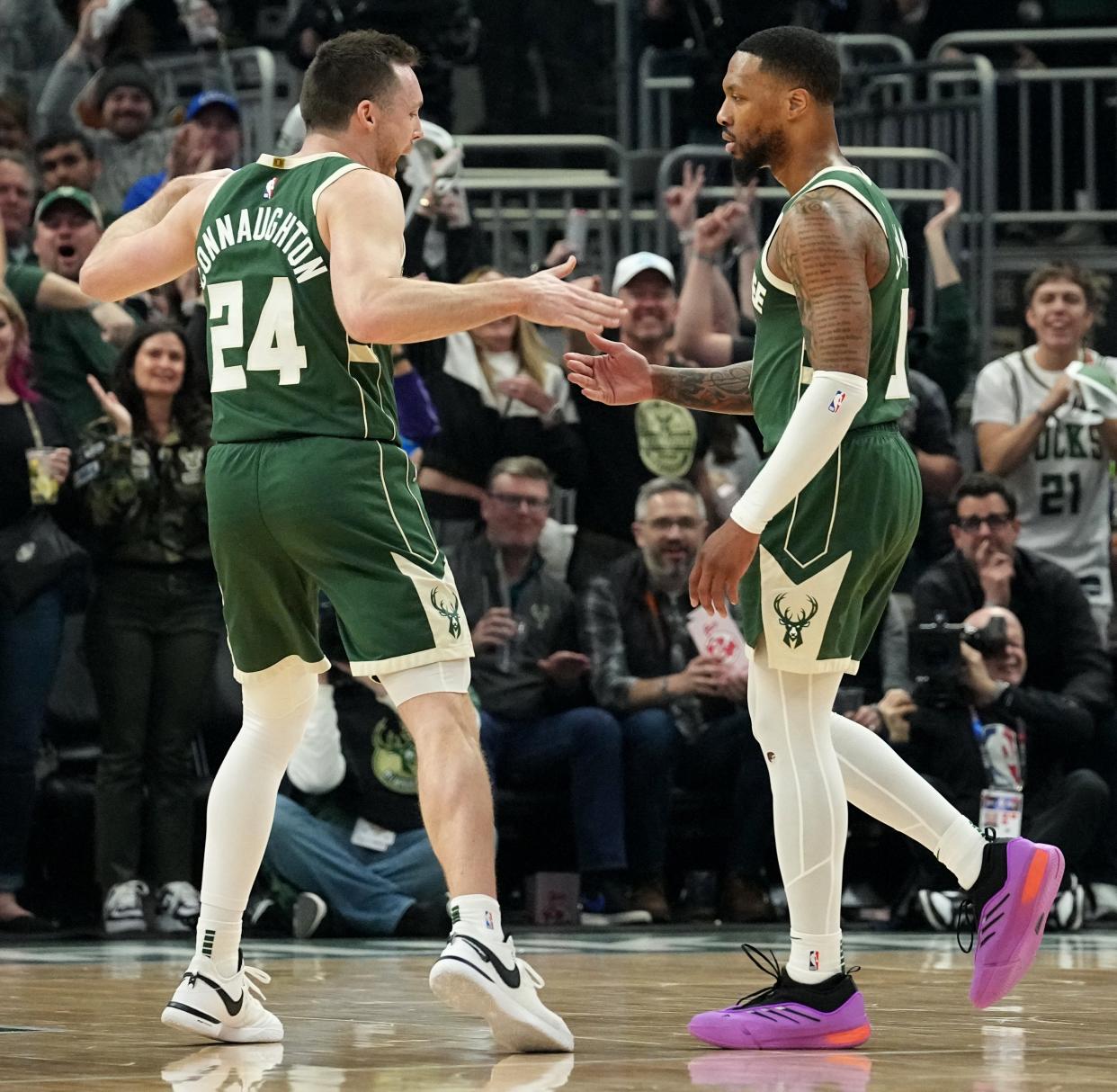 Milwaukee Bucks guard Pat Connaugton (24) celebrates with guard Damian Lillard (0) drawing a foul during the first half of their first round playoff game against the Indiana Pacers Sunday, April 21, 2024 at Fiserv Forum in Milwaukee, Wisconsin.

Mark Hoffman/Milwaukee Journal Sentinel