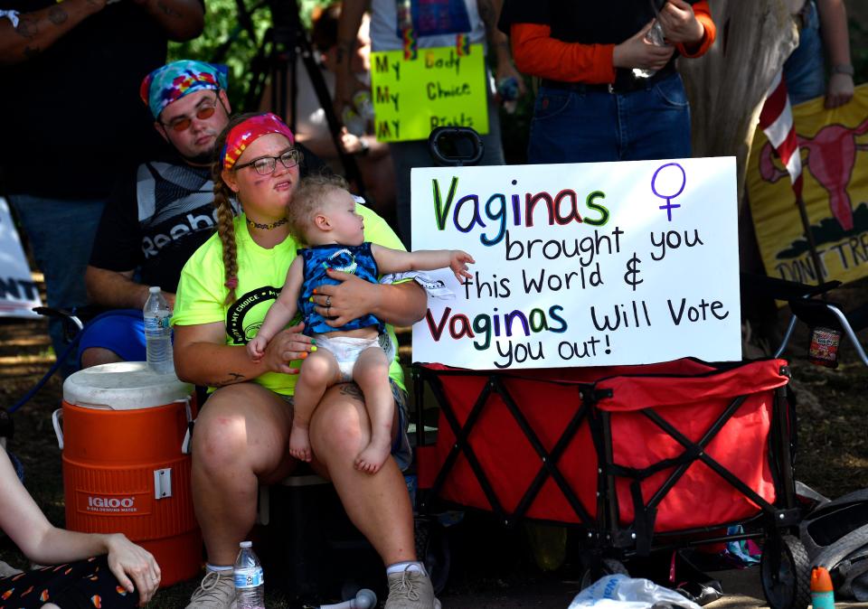 Attendees at the Rally and March for Reproductive Rights listen to speakers in Everman Park.