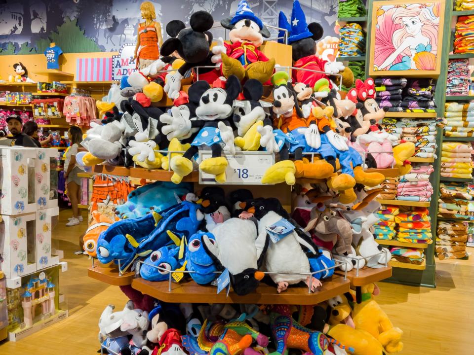 circular shelves of disney stuffed animals at a disney store