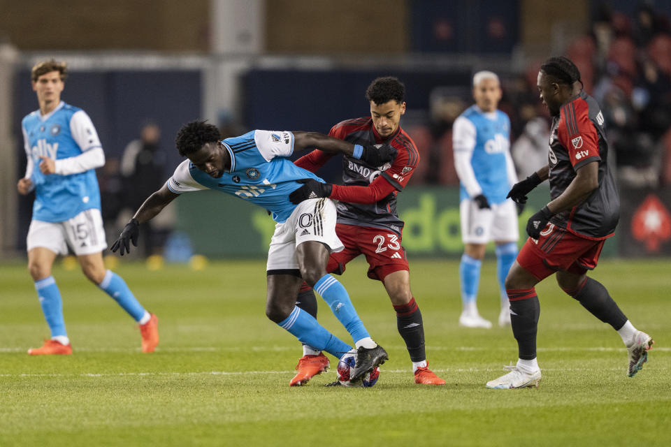 Charlotte FC midfielder Derrick Jones (20) competes for the ball against Toronto FC midfielder Brandon Servania (23) during the first half of an MLS soccer match Saturday, April 1, 2023, in Vancouver, British Columbia. (Andrew Lahodynskyj/The Canadian Press via AP)