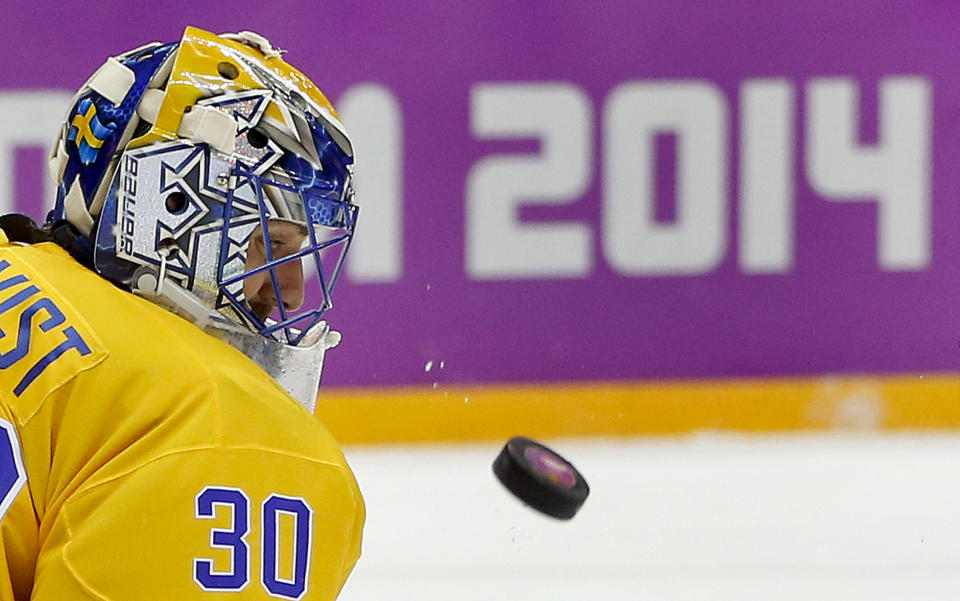 Sweden goaltender Henrik Lundqvist blocks a shot by Finland during the third period of a men's semifinal ice hockey game at the 2014 Winter Olympics, Feb. 21, 2014, in Sochi, Russia.