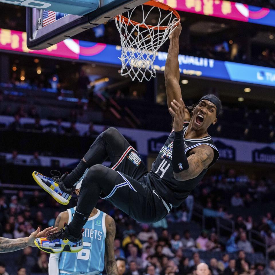 Terance Mann lets out a yell as he dunks for the Clippers.