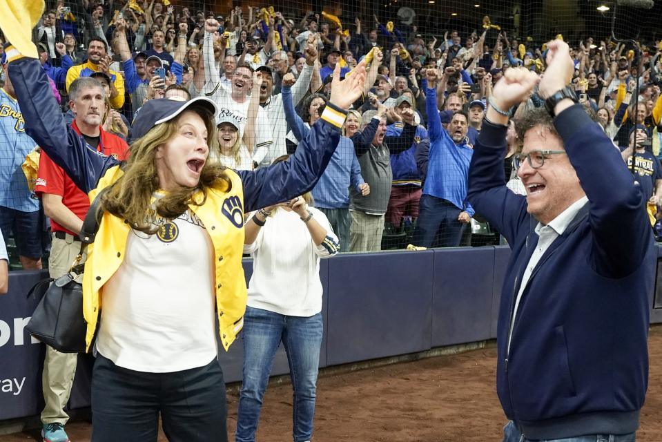Milwaukee Brewers' owner Mark Attanasio and wife Debbie celebrate after clinching the National League Central Division after a baseball game against the St. Louis Cardinals Tuesday, Sept. 26, 2023, in Milwaukee. (AP Photo/Morry Gash)