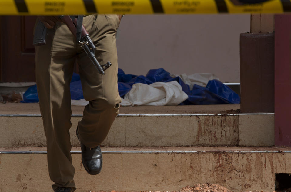 A policeman walks close to blood-stained stairs at the scene of a suicide bombing at St. Sebastian Church in Negombo, Sri Lanka, April 22, 2019. (Photo: Gemunu Amarasinghe/AP)