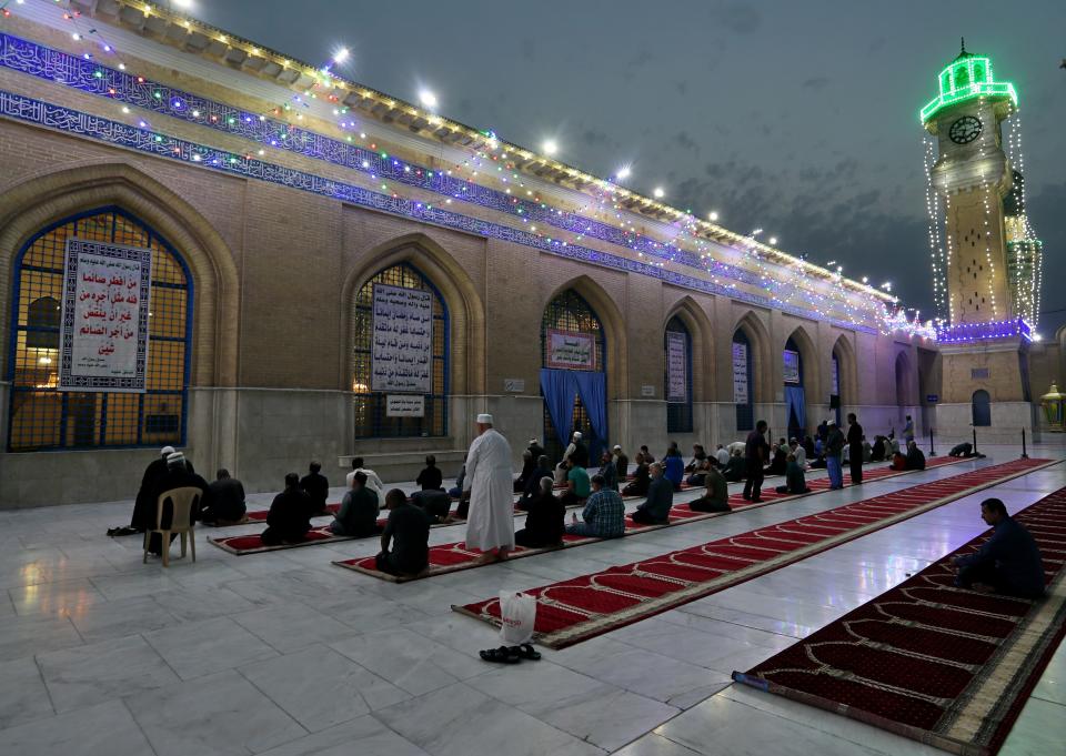 FILE - In this Saturday, April 10, 2021, file photo, Muslims perform evening prayer at the Sunni shrine of Abdul-Qadir al-Gailani, ahead of the upcoming Muslim fasting month of Ramadan, in Baghdad, Iraq. Muslims are facing their second Ramadan in the shadow of the pandemic. Many Muslim majority countries have been hit by an intense new coronavirus wave. While some countries imposed new Ramadan restrictions, concern is high that the month’s rituals could stoke a further surge. (AP Photo/Khalid Mohammed, File)
