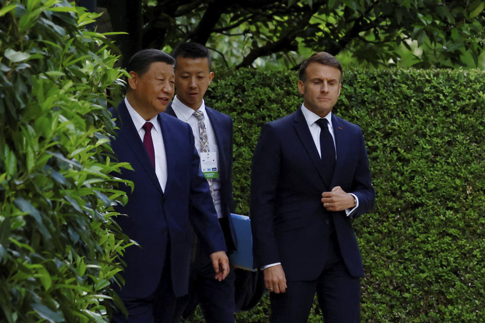 China's President Xi Jinping, left, and French President Emmanuel Macron walk in garden of the Elysee Palace after a joint statement, Monday, May 6, 2024 in Paris. French President Emmanuel Macron put trade disputes and Ukraine-related diplomatic efforts on top of the agenda for talks Monday with Chinese President Xi Jinping, who arrived in France for a two-day state visit opening his European tour. (Sarah Meyssonnier/Pool via AP)
