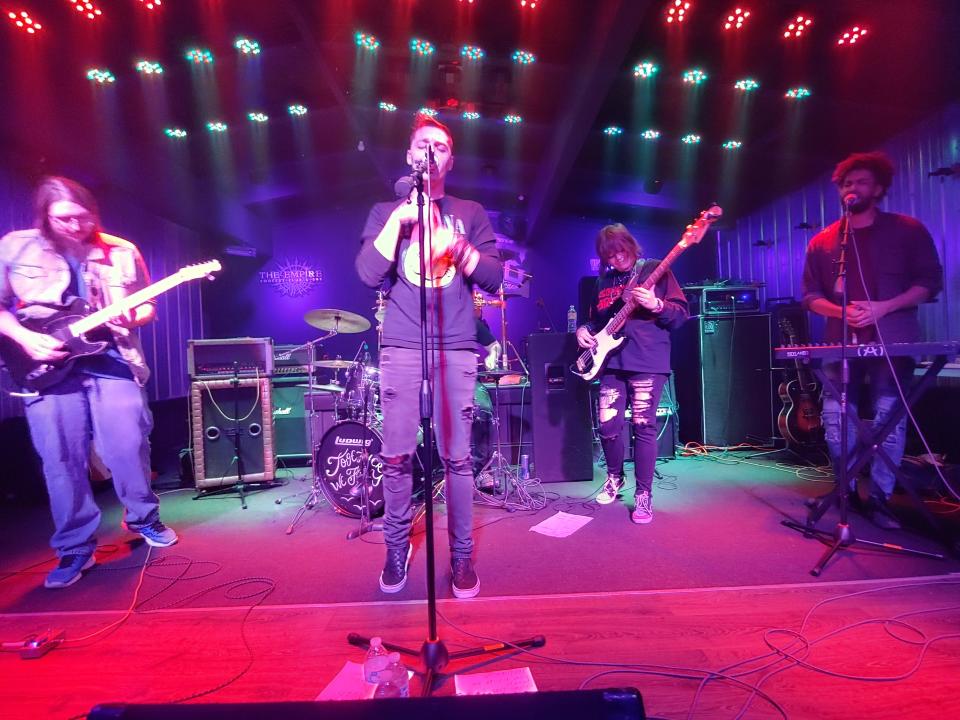 Together We Fly’s Slade Young, from left, Levi Frechette, Cassidy Paige and Johnstone perform in March at the Empire Concert Club in Akron. Drummer AceHighBeats is in back.