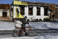 A man carries humanitarian aid after he got it in a distribution spot in the town of Orekhovo, Zaporizhzhya region, Ukraine, Wednesday, Feb. 8, 2023. (AP Photo/Andriy Andriyenko)