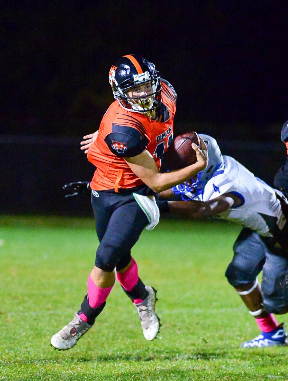 Diman’s Sam Perry breaks a tackle to keep the play alive during last season’s game against Southeastern.