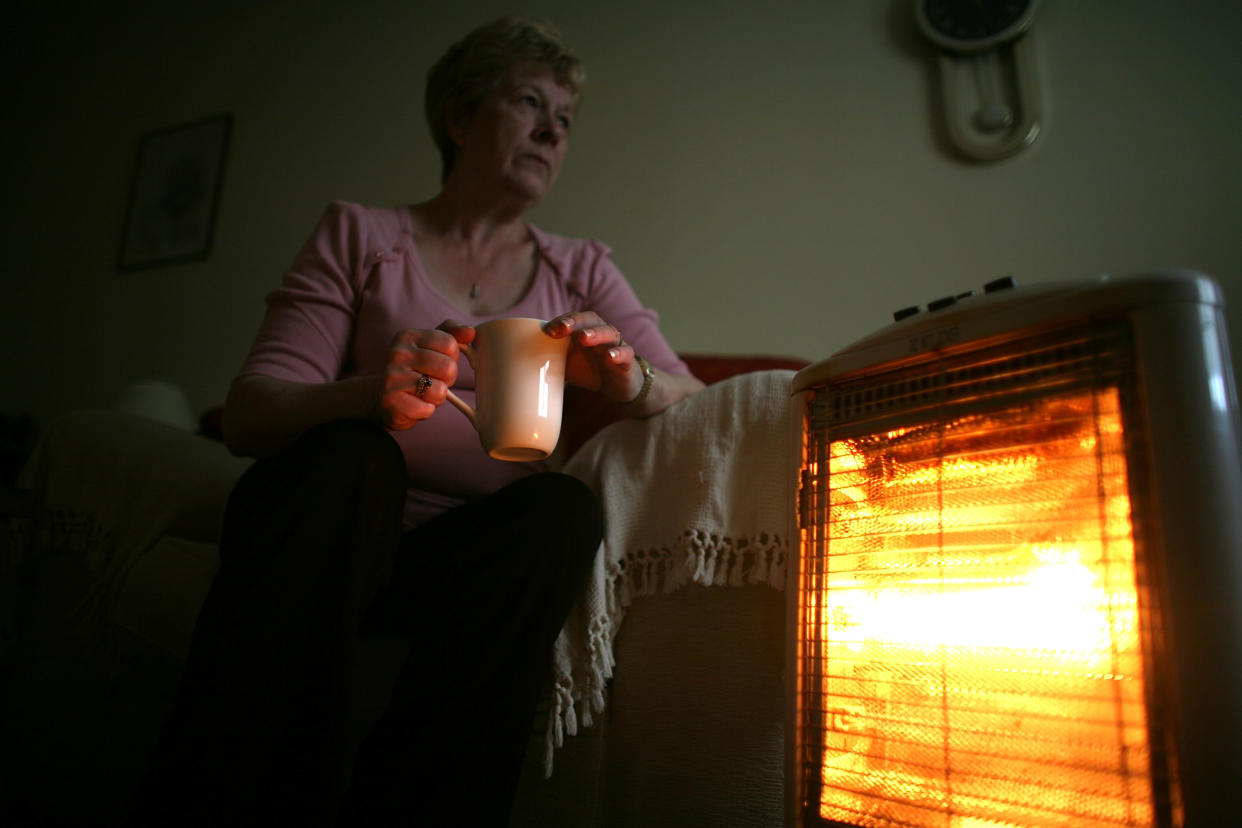 CONWY, UNITED KINGDOM - NOVEMBER 06:  In this photo illustration an old age pensioner keeps warm with the aid of an electric heater on November 6, 2008, in Conwy, Wales. With the recent high rise in fuel and energy bills many senior citizens are facing a cold winter. The UK's National pensioner Convention has called for a higher basic state pension for the over 60's.  (Photo by Christopher Furlong/Getty Images)