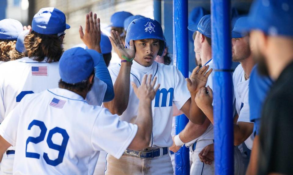 Modesto’s Paul Contreras is greeted by teammates after scoring during the 3C2A NorCal Regional playoff game with Sacramento City College at Modesto Junior College in Modesto, Calif., Friday, May 3, 2024. Modesto won the game 6-3. Andy Alfaro/aalfaro@modbee.com