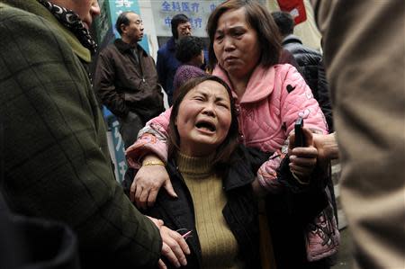 A woman cries after her parent was killed in a knifing incident in Changsha, Hunan province March 14, 2014. At least three people are dead after a knifing incident in central China's Changsha city, state media reported on Friday, in what appeared to be a dispute involving market vendors from the restive far western region of Xinjiang. REUTERS/Stringer
