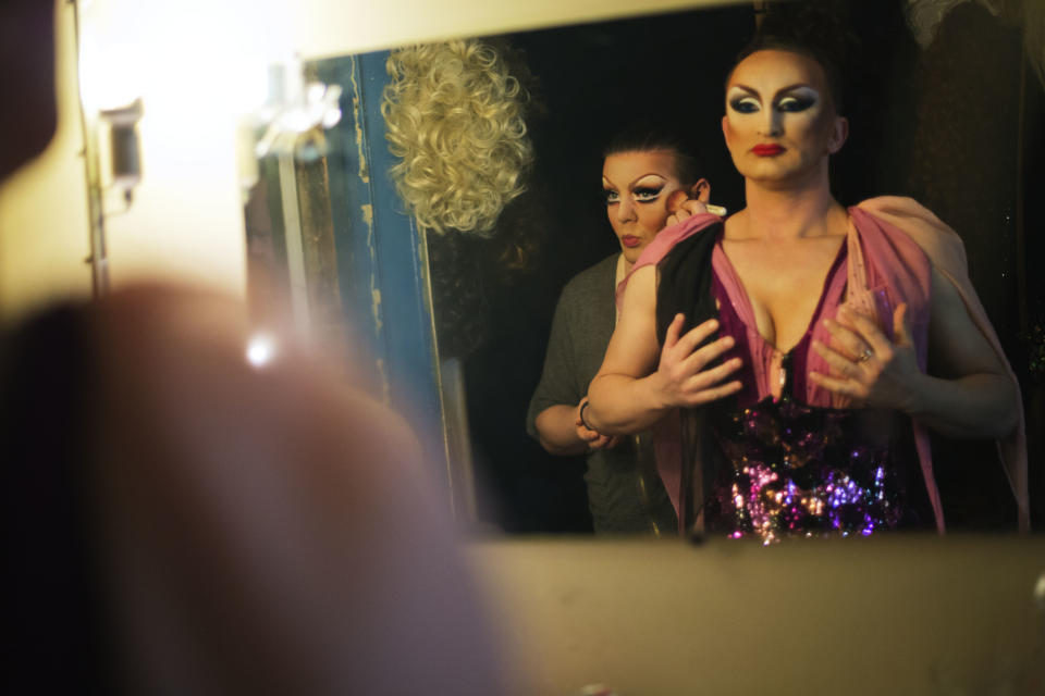 In this photo taken Saturday, Feb. 8, 2014, performers Penelopa, right, and Veranda, left, who would only give their stage names, get ready backstage before a performance at the Mayak cabaret, the most reputable gay club in Sochi, Russia, host to 2014 Winter Olympics. Russia adopted a law last year, prohibiting vaguely defined propaganda of non-traditional sexual relations and pedophilia. The legislation makes it illegal to disseminate information to children even if it merely shows that gay people are just like everybody else. At Mayak, packed on Saturday night, gay men and women steered away from discussing the law, preferring to enjoy life, closeted as it is. About a hundred people were chatting at the bar, sitting in armchairs or dancing. Couples were sharing kisses. Everyone was waiting for the club's specialty: a drag show. At 1.30 a.m. on Sunday, the music stopped and the show began. (AP Photo/David Goldman)